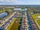 Expansive aerial view of townhomes, a pond, a lake, and the surrounding lush landscape at 11641 Crowned Sparrow Ln, Tampa, FL 33626