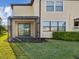 Townhome backyard with a screened-in lanai and view of manicured landscaping on a sunny day at 11641 Crowned Sparrow Ln, Tampa, FL 33626