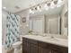 Bright bathroom featuring a shower and tub, modern vanity, and neutral color palette at 11641 Crowned Sparrow Ln, Tampa, FL 33626