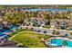 A scenic view of manicured landscaping, townhomes, and a community pool area at 11641 Crowned Sparrow Ln, Tampa, FL 33626