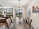 The dining room overlooks the backyard and pond and flows into the living room at 11641 Crowned Sparrow Ln, Tampa, FL 33626