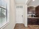 Foyer with hardwood floors, natural light, and view of kitchen features at 11641 Crowned Sparrow Ln, Tampa, FL 33626