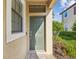 Inviting front entryway with a welcome mat and manicured landscaping at 11641 Crowned Sparrow Ln, Tampa, FL 33626