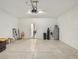 Spacious two car garage with a sealed concrete floor and door to the home at 11641 Crowned Sparrow Ln, Tampa, FL 33626
