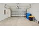 Spacious two car garage with a sealed concrete floor and door to the home at 11641 Crowned Sparrow Ln, Tampa, FL 33626