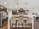 Spacious kitchen with a large island, stainless steel appliances, and dark wood cabinetry at 11641 Crowned Sparrow Ln, Tampa, FL 33626