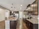 Spacious kitchen features wood floors, stainless steel appliances, granite countertops, and a center island at 11641 Crowned Sparrow Ln, Tampa, FL 33626