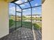 Screened-in lanai with view of pond and neighborhood at 11641 Crowned Sparrow Ln, Tampa, FL 33626