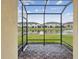 Screened-in lanai with view of pond and neighborhood at 11641 Crowned Sparrow Ln, Tampa, FL 33626
