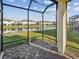 Screened-in lanai with view of pond and neighborhood at 11641 Crowned Sparrow Ln, Tampa, FL 33626