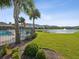 View of a pond and fountain with landscaping and community pool in background at 11641 Crowned Sparrow Ln, Tampa, FL 33626