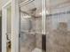 Modern shower stall with sleek tile work, a glass door, and contemporary fixtures for a spa-like experience at 11641 Crowned Sparrow Ln, Tampa, FL 33626