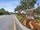 West Lake entrance sign surrounded by colorful landscaping, with trees and other buildings in the background at 11641 Crowned Sparrow Ln, Tampa, FL 33626