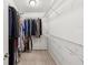 Functional walk-in closet with ample shelving, rods, and storage space for organized clothing and accessories at 11641 Crowned Sparrow Ln, Tampa, FL 33626