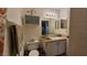 Standard bathroom with a single sink vanity, toilet, and tile backsplash at 11711 Raintree Village Blvd # C, Temple Terrace, FL 33617