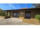 A close exterior view of property with address number, dark framed windows, tan exterior, and well maintained landscape at 11711 Raintree Village Blvd # C, Temple Terrace, FL 33617