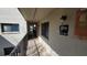 Exterior building hallway with unit number, outdoor lighting, and a covered walkway at 11711 Raintree Village Blvd # C, Temple Terrace, FL 33617