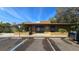 Exterior view of property with parking area and accessible parking space, inviting entryway, and well-maintained landscaping at 11711 Raintree Village Blvd # C, Temple Terrace, FL 33617