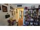 Inviting hallway adorned with art, books, and personal touches, leading to a light-filled living area at 11711 Raintree Village Blvd # C, Temple Terrace, FL 33617