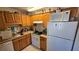 Functional kitchen with wooden cabinetry, modern appliances, and ample countertop space at 11711 Raintree Village Blvd # C, Temple Terrace, FL 33617
