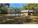Neighborhood pool surrounded by trees, lounge chairs and a bath house at 11711 Raintree Village Blvd # C, Temple Terrace, FL 33617