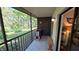 Relaxing screened porch with outdoor seating and a view of the tranquil wooded surroundings at 11711 Raintree Village Blvd # C, Temple Terrace, FL 33617