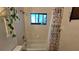 Well-maintained tiled shower and tub combination with a bright window at 11711 Raintree Village Blvd # C, Temple Terrace, FL 33617