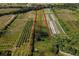 A bird's-eye view showcasing land and farm rows outlined in red at 11716 Cr 672 Hwy, Riverview, FL 33579
