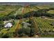Aerial view of property showcasing land, home, and surroundings outlined in red at 11716 Cr 672 Hwy, Riverview, FL 33579