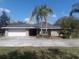 Charming single-story home featuring a large front yard with lush landscaping and a two-car garage at 11716 Cr 672 Hwy, Riverview, FL 33579