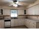 Bright kitchen with white cabinetry, tile floors, and ample counter space for meal preparation at 11716 Cr 672 Hwy, Riverview, FL 33579