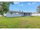 Spacious backyard showcasing the home's exterior and a screened-in patio at 11973 80Th Ave, Seminole, FL 33772
