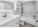 Updated bathroom features a marble tile surround, a tub, and a modern vanity at 11973 80Th Ave, Seminole, FL 33772