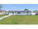 Charming home featuring solar panels, a well-manicured lawn, and an attached one-car garage at 11973 80Th Ave, Seminole, FL 33772