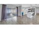 Open-concept kitchen featuring stainless steel appliances, breakfast bar, and sliding glass doors to screened in porch at 11973 80Th Ave, Seminole, FL 33772