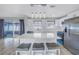 Modern kitchen with stainless steel appliances, breakfast bar with seating, and stylish pendant lighting at 11973 80Th Ave, Seminole, FL 33772