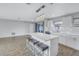 Bright, open floor plan featuring an island with seating and modern pendant lighting at 11973 80Th Ave, Seminole, FL 33772
