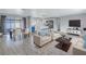 Open-concept living and dining area features tile floors and modern furnishings throughout at 11973 80Th Ave, Seminole, FL 33772