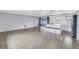 Spacious open floor plan featuring wood-look tile flowing from the living area to the modern kitchen at 11973 80Th Ave, Seminole, FL 33772