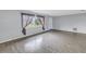 Open living room featuring wood-look tile, large window with curtains, and neutral paint at 11973 80Th Ave, Seminole, FL 33772