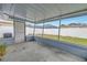 Covered and screened back porch with a view of the fenced backyard at 11973 80Th Ave, Seminole, FL 33772