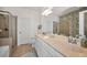 Bathroom features double sinks, shower, toilet, white cabinetry, and decorative herringbone accent wall at 13207 San Blas Loop, Largo, FL 33774