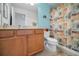 Bathroom featuring a vanity, sink, toilet, and a shower with a tropical-themed shower curtain at 13207 San Blas Loop, Largo, FL 33774