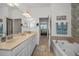 Main bath includes a soaking tub, glass-enclosed shower, double sinks, and stylish tile at 13207 San Blas Loop, Largo, FL 33774