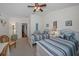 Bright bedroom with two beds, ceiling fan, and charming nautical decor at 13207 San Blas Loop, Largo, FL 33774