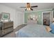 Well-lit bedroom featuring a ceiling fan, closet, dresser, and a relaxing green wall at 13207 San Blas Loop, Largo, FL 33774