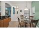 Breakfast nook featuring a glass table, four chairs and access to the kitchen, living room and stairway at 13207 San Blas Loop, Largo, FL 33774