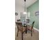 Bright breakfast nook featuring a four-chair glass table, green walls and large windows with natural light at 13207 San Blas Loop, Largo, FL 33774