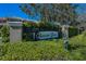 Beacon Trace community sign surrounded by green foliage and a clear blue sky at 13207 San Blas Loop, Largo, FL 33774