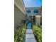Inviting walkway leading to the front door with a secure black metal gate at 13207 San Blas Loop, Largo, FL 33774